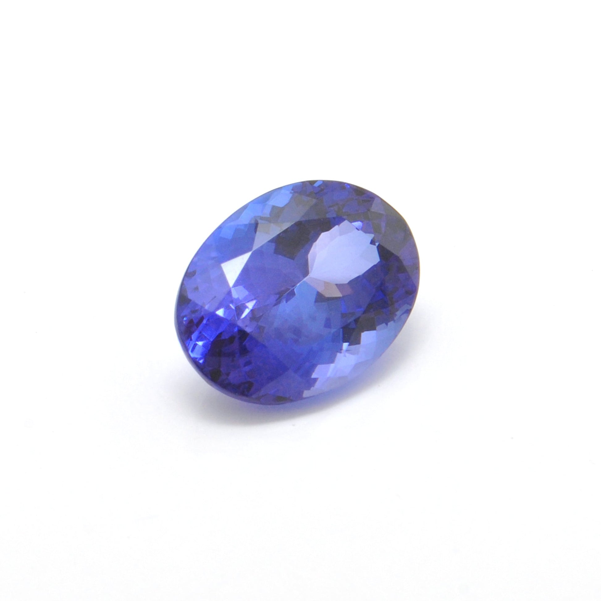 Close-up of a SAR Gems natural tanzanite gemstone, 6.25 carats, faceted oval cut, 6x10mm, showcasing violet-blue color and brilliant clarity