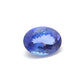 Close-up of a SAR Gems natural tanzanite gemstone, 6.25 carats, faceted oval cut, 6x10mm, showcasing violet-blue color and brilliant clarity