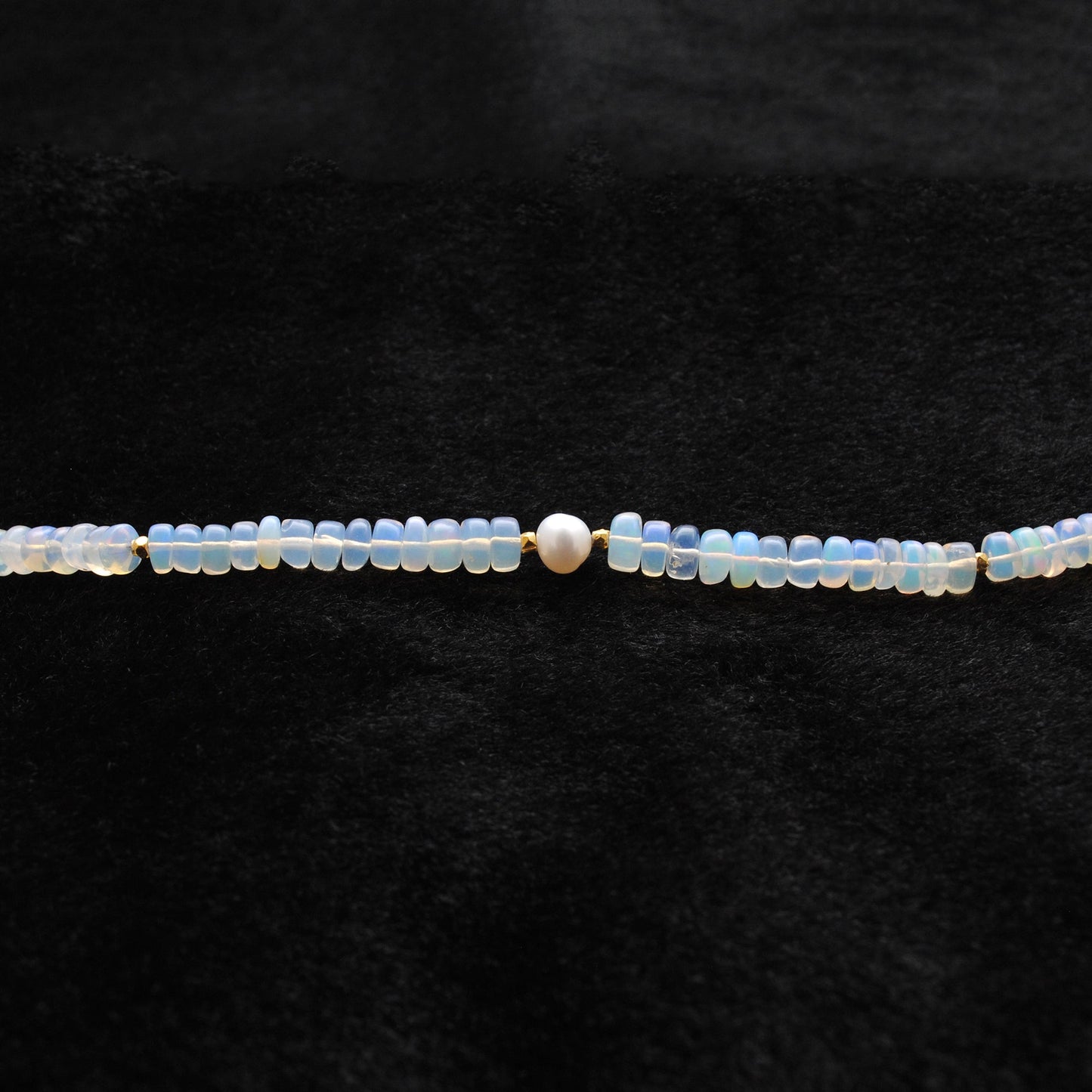 Beaded Necklace featuring 925 Sterling Silver, Opal beads, and Freshwater Pearl centerpiece on a black background.