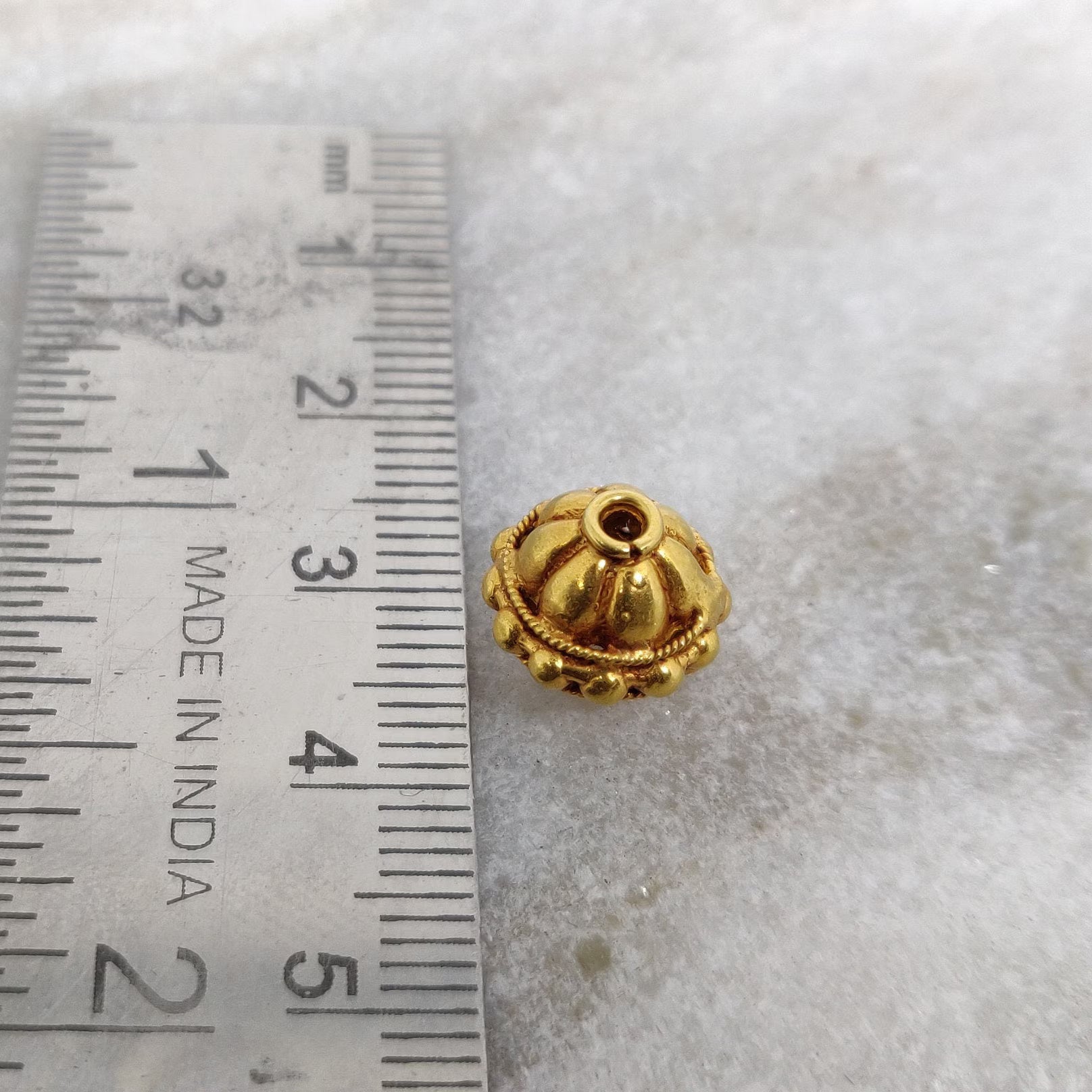 Premium solid 18K gold round spacer bead jewelry finding on white background